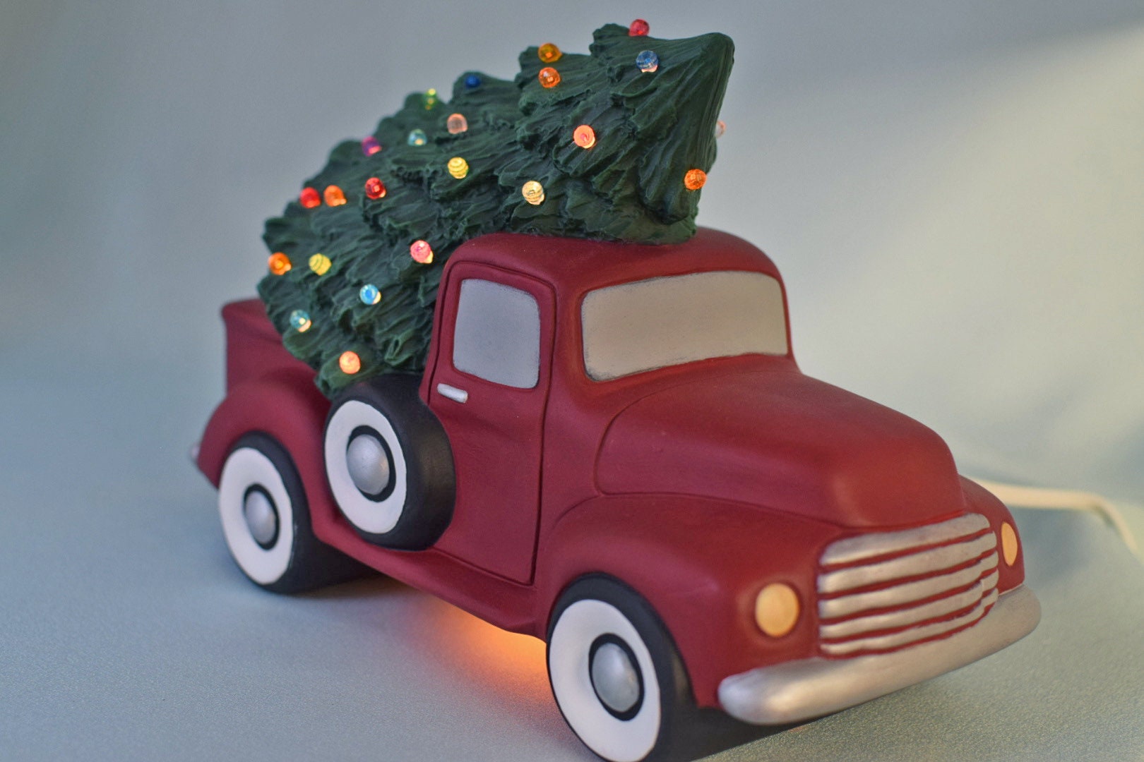 red pickup truck with christmas tree lights