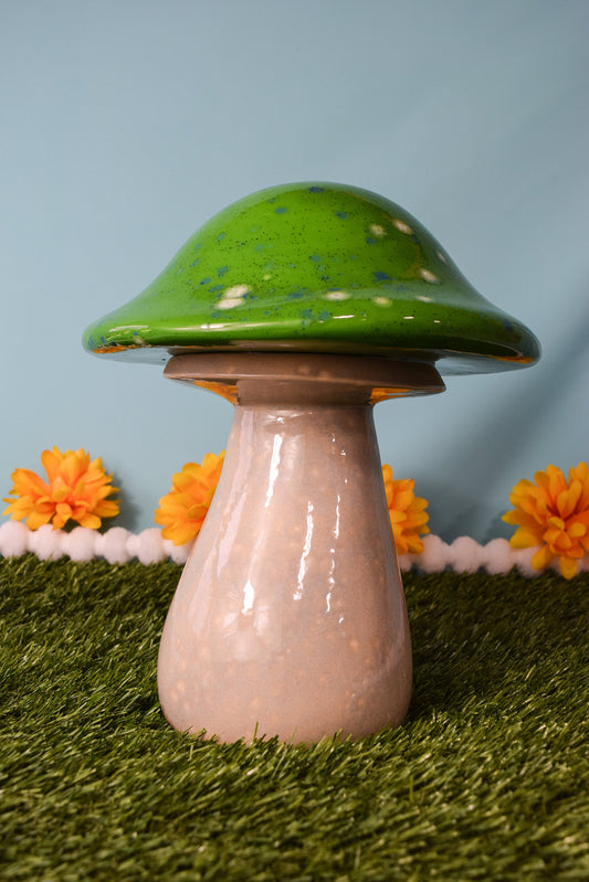 large green speckled garden mushroom sculpture